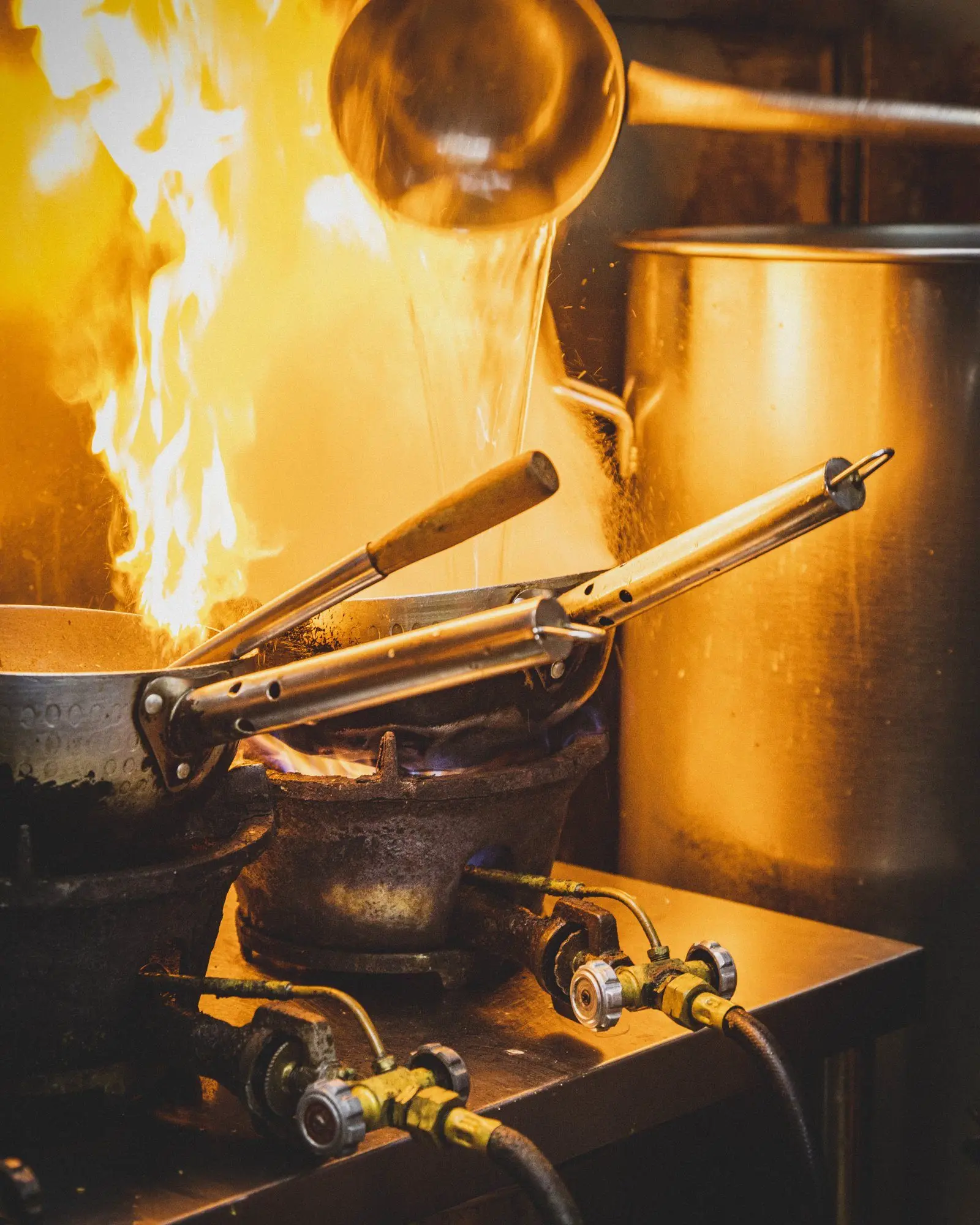 Hawker chef cooking a wok dish at a partnering stall in Singapore